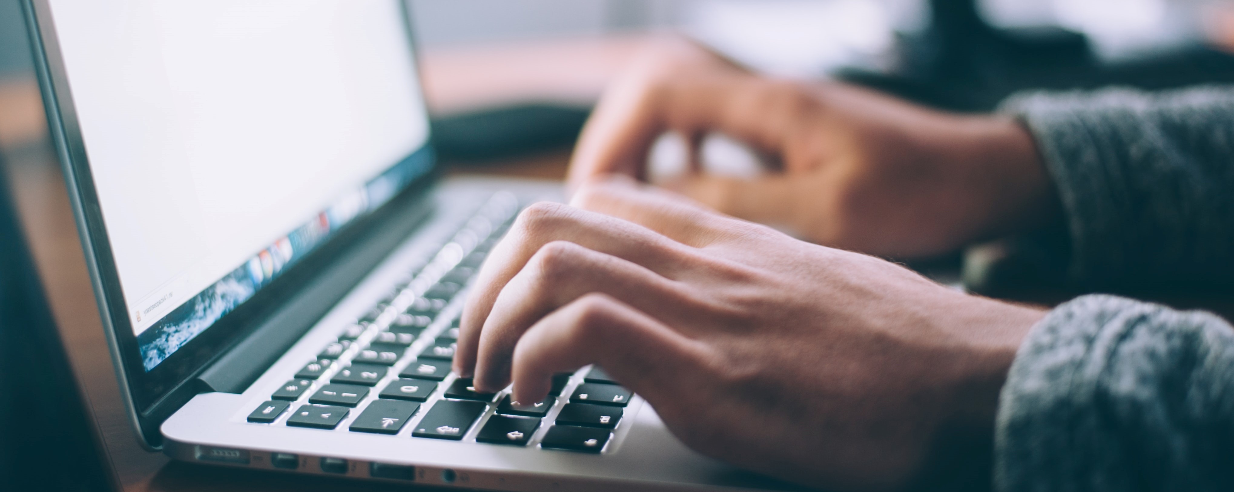 Someone typing on a computer