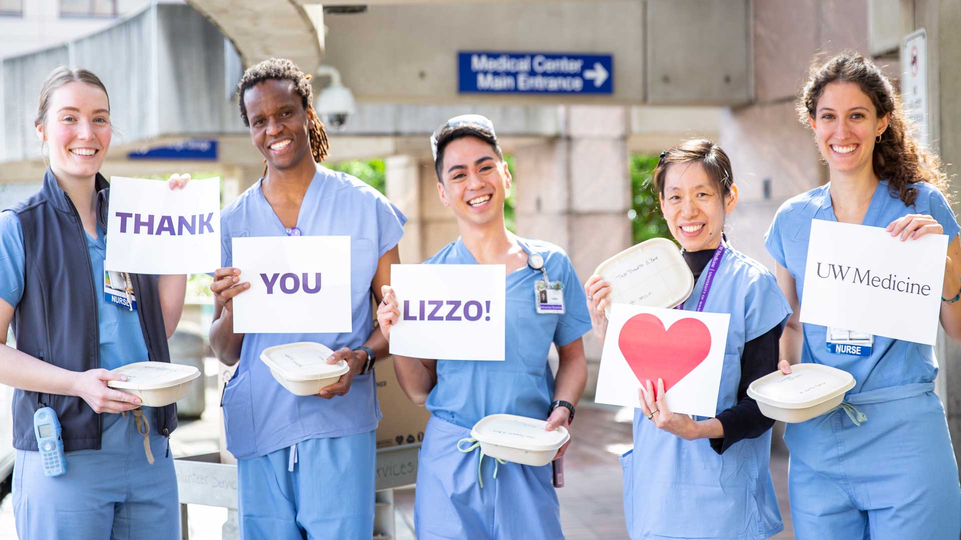 nurses holding up signs thanking lizzo for her donations